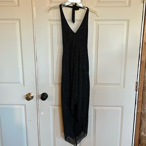 Size M junior black dress with longer back and V neck, cut out back.